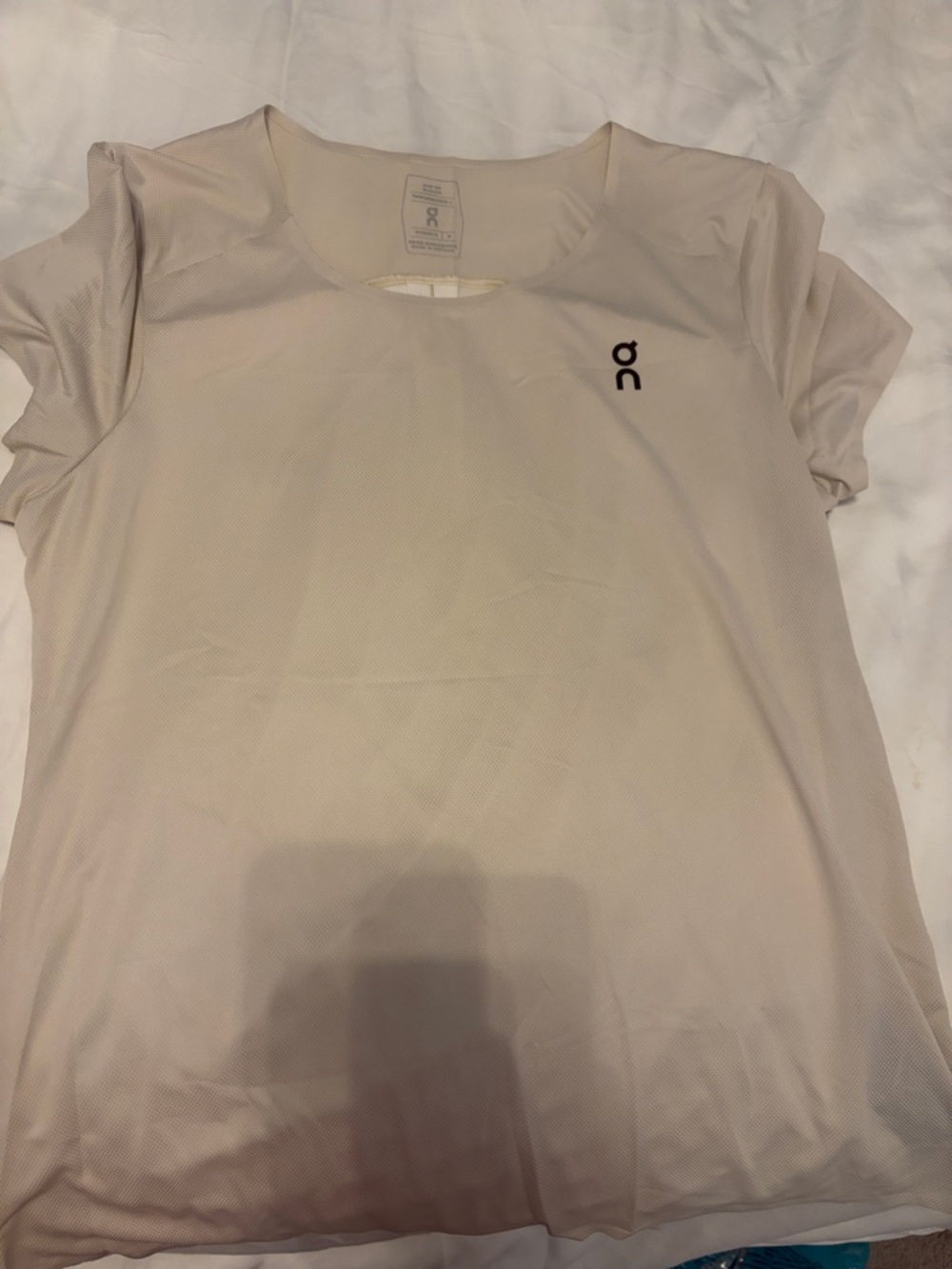 On Running Women’s Short Sleeve Performance Tee — Light Beige with Black Logo